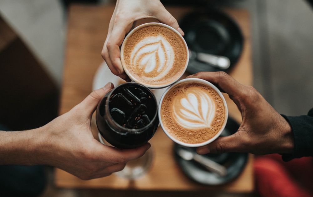 Colleagues tossing their cup of coffee.